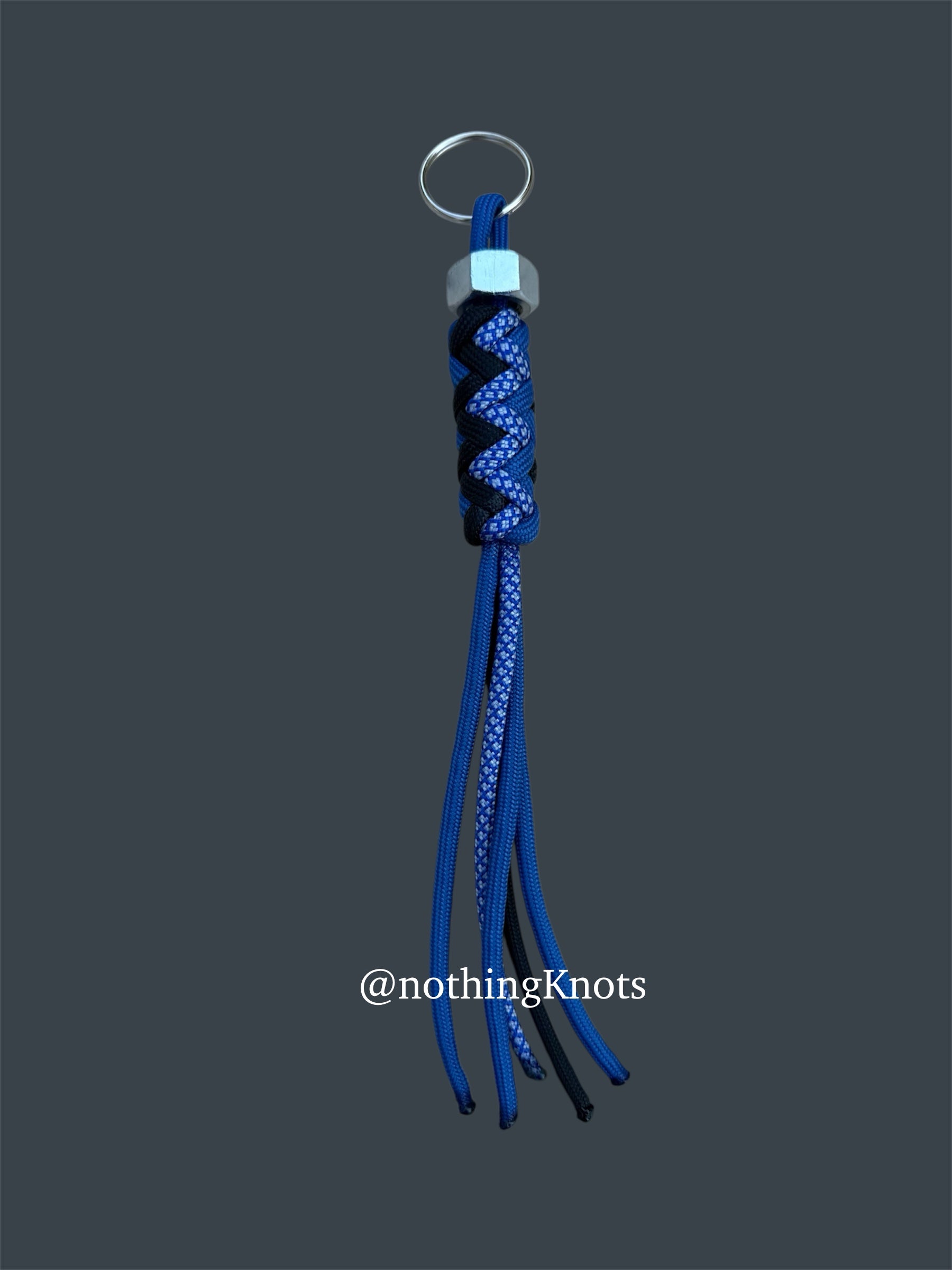Paracord Decorative Keychain in Blue, Black, and Blue with White Diamonds on a split ring with hex nut