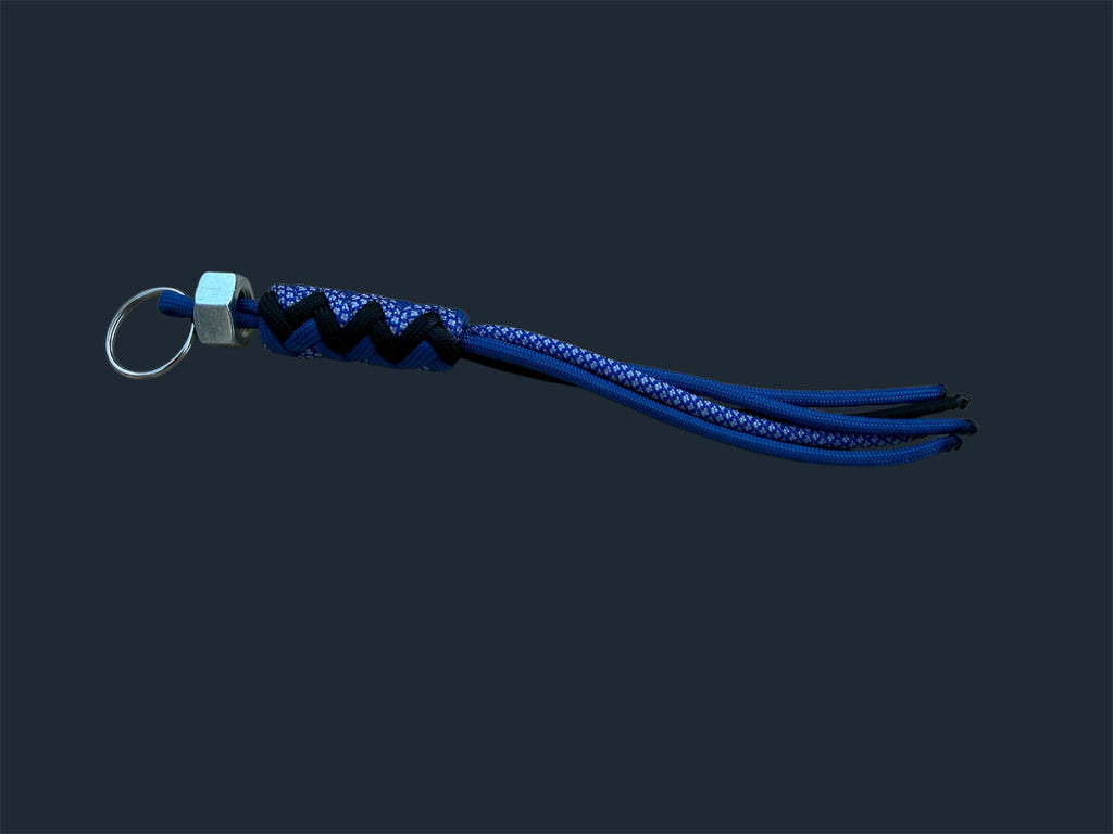 Paracord Decorative Keychain in Blue, Black, and Blue with White Diamonds on a split ring with hex nut