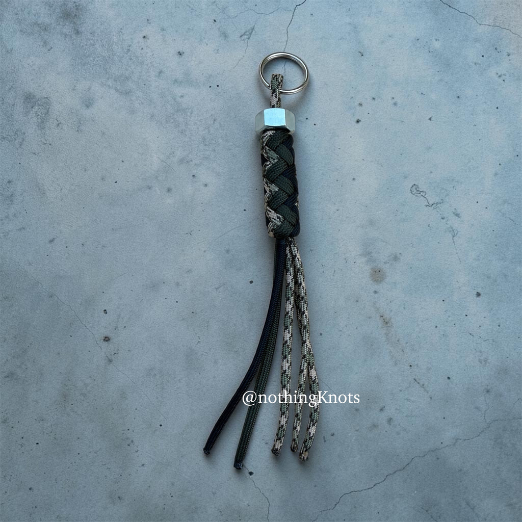 Paracord Decorative Keychain in OD Green, Black, and Camo on a split ring with hex nut