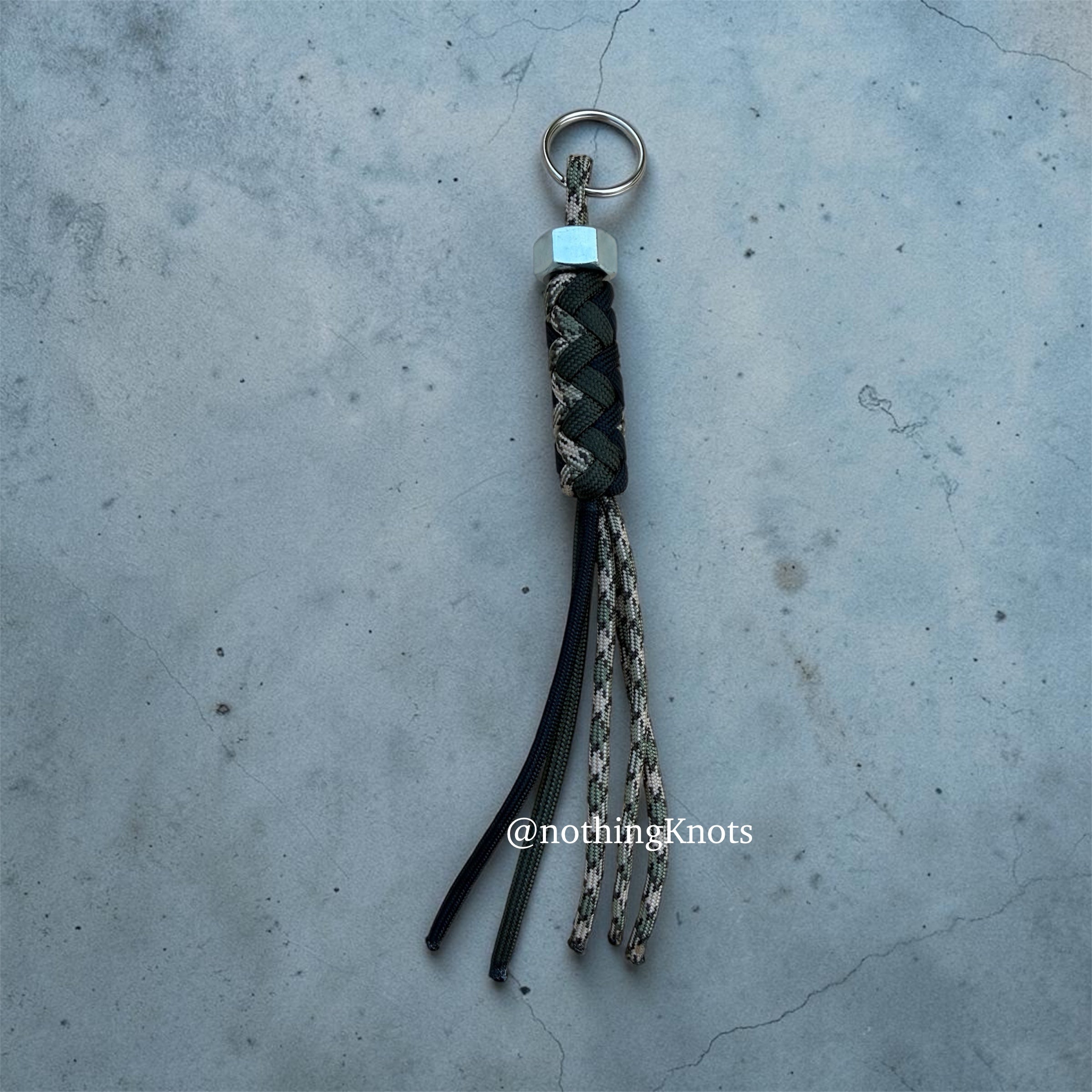Paracord Decorative Keychain in OD Green, Black, and Camo on a split ring with hex nut