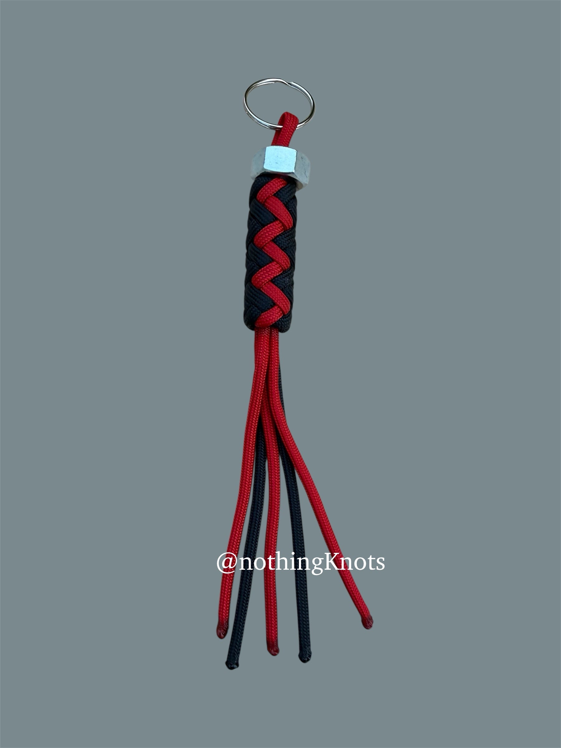 Paracord Decorative Keychain in Black and Red on a split ring with hex nut