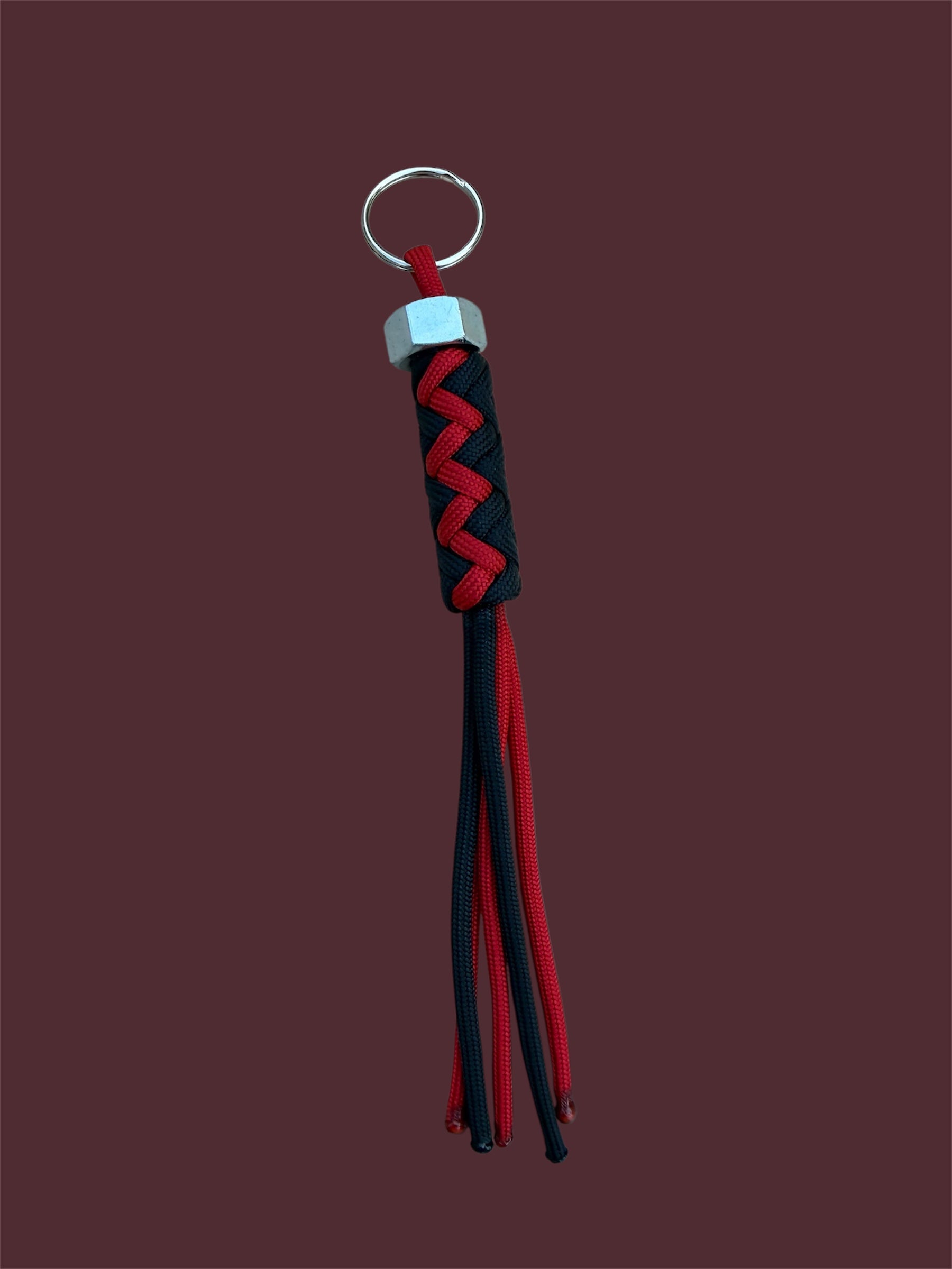Paracord Decorative Keychain in Black and Red on a split ring with hex nut