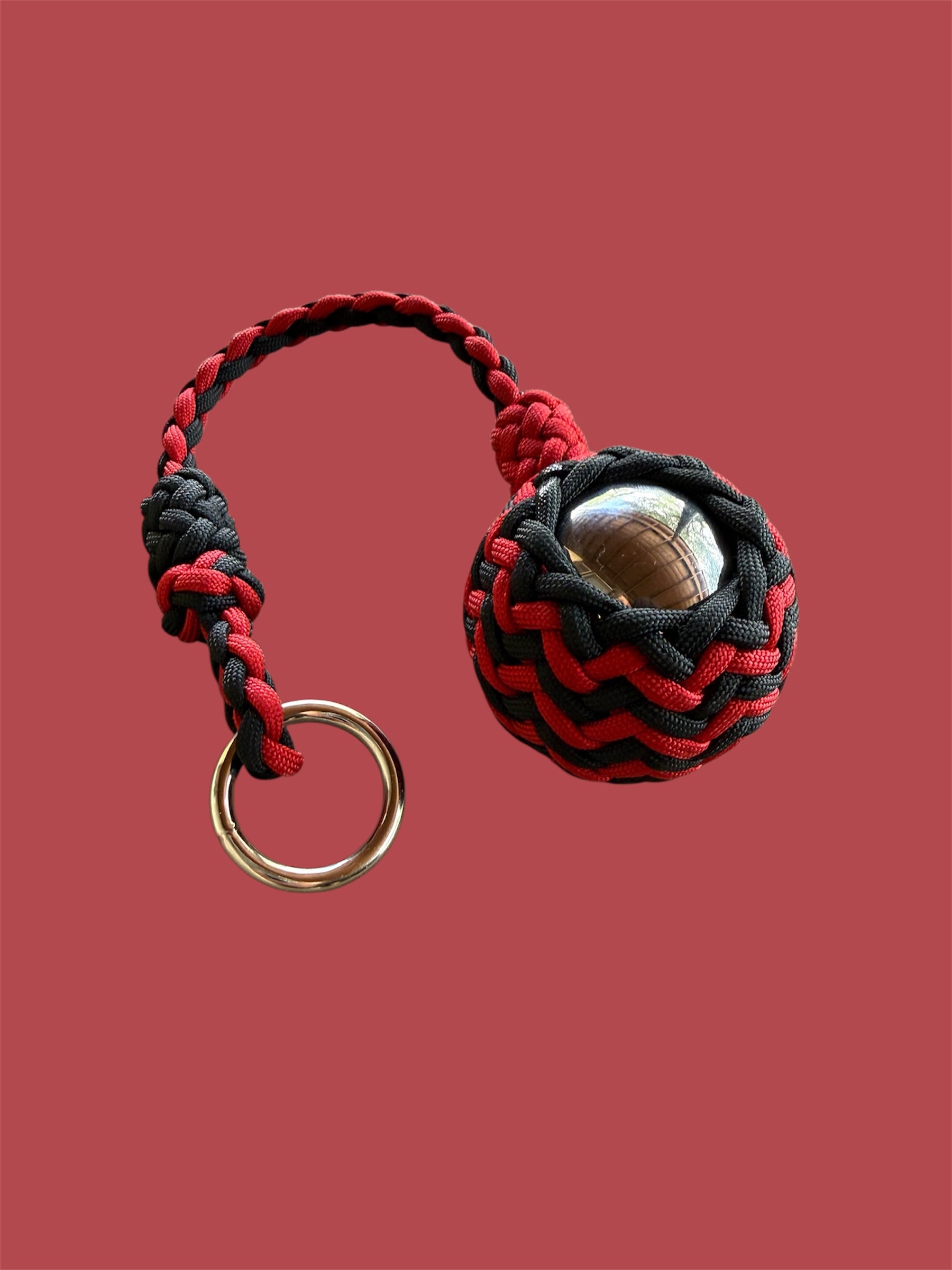 Decorative Paracord Wrapped 2 inch Steel Ball in Red and Black monkey fist style on a silver welded O ring