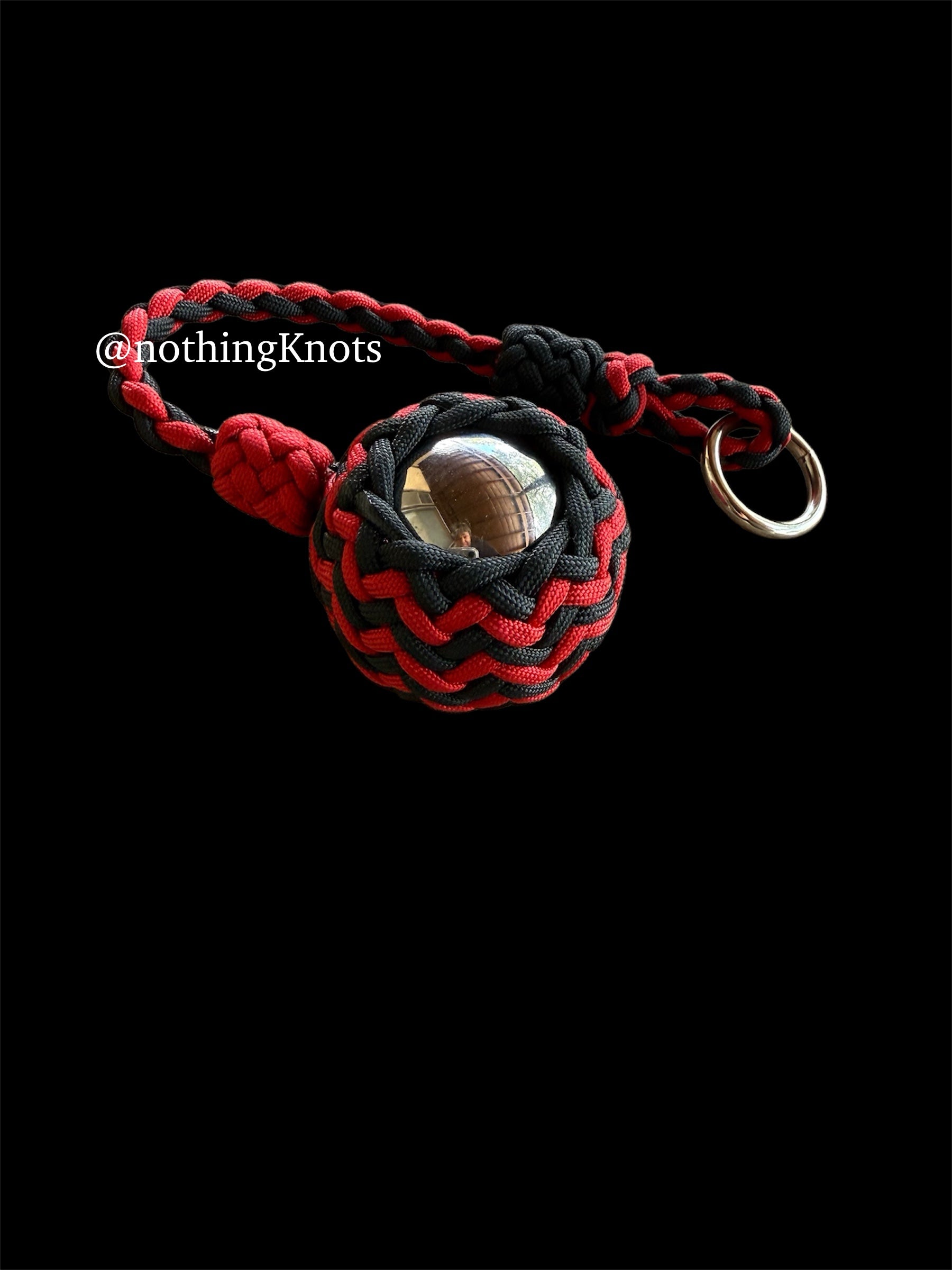 Decorative Paracord Wrapped 2 inch Steel Ball in Red and Black monkey fist style on a silver welded O ring