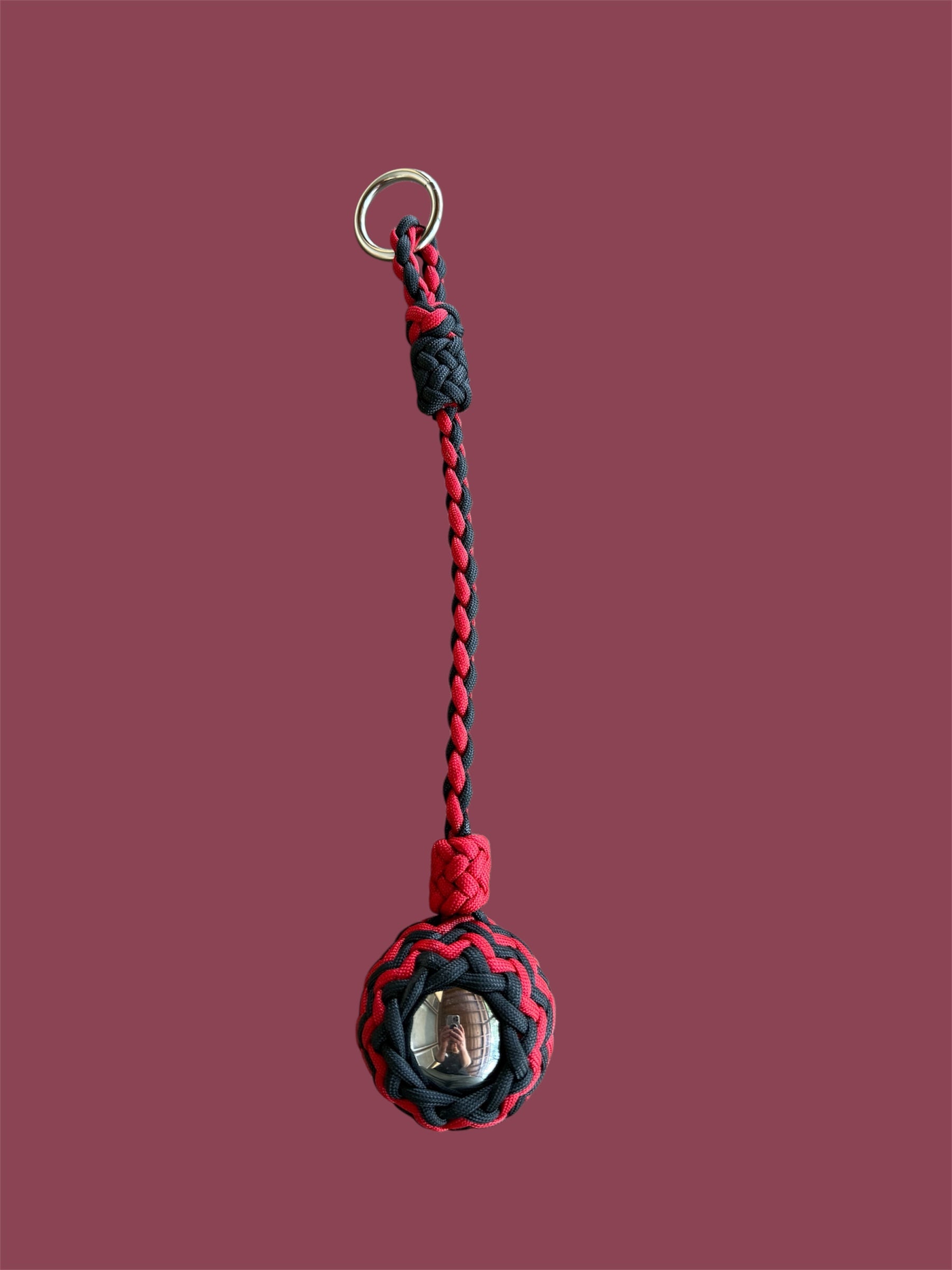 Decorative Paracord Wrapped 2 inch Steel Ball in Red and Black monkey fist style on a silver welded O ring
