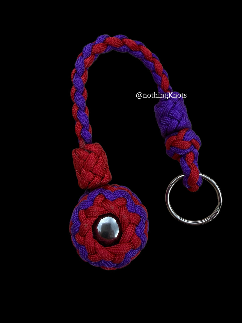 Decorative Paracord Wrapped 1.25 inch steel ball in Imperial Red and Acid Purple on a split ring