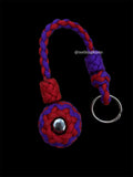 Decorative Paracord Wrapped 1.25 inch steel ball in Imperial Red and Acid Purple on a split ring