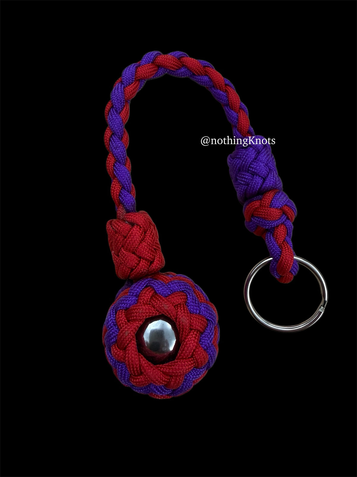 Decorative Paracord Wrapped 1.25 inch steel ball in Imperial Red and Acid Purple on a split ring