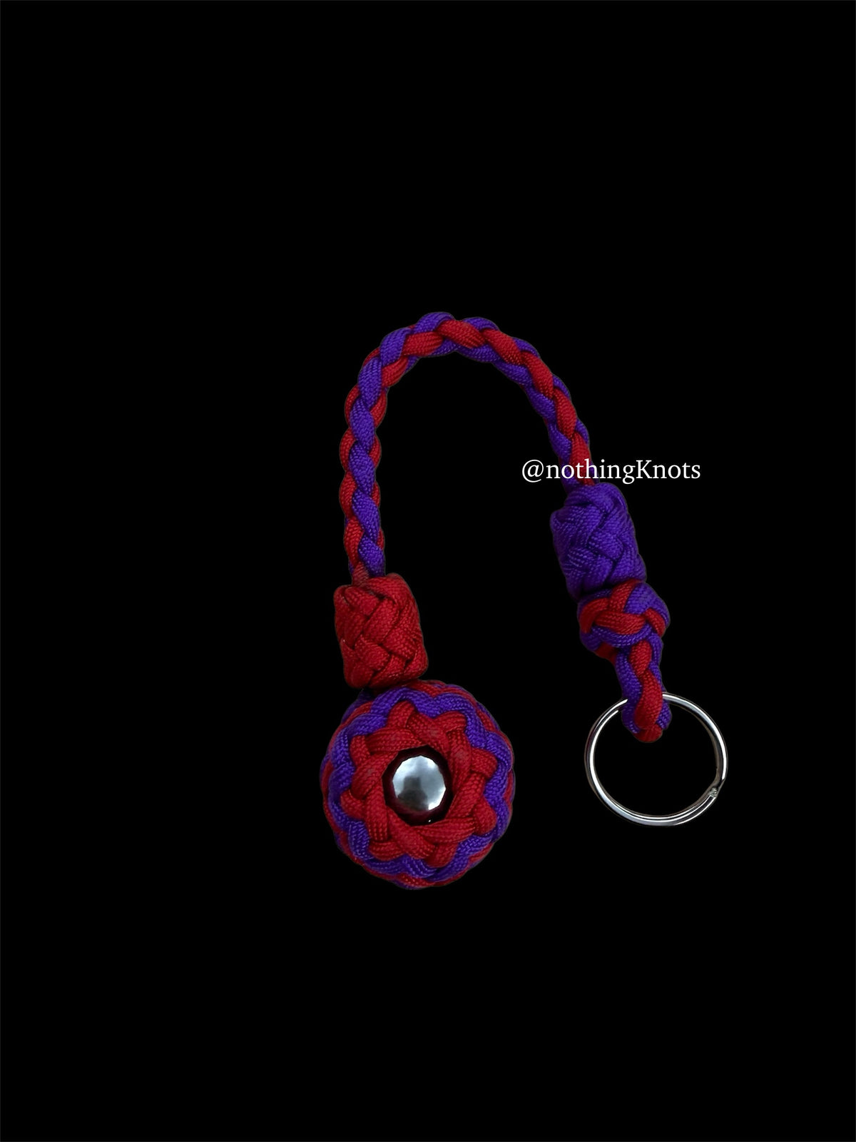 Decorative Paracord Wrapped 1.25 inch steel ball in Imperial Red and Acid Purple on a split ring