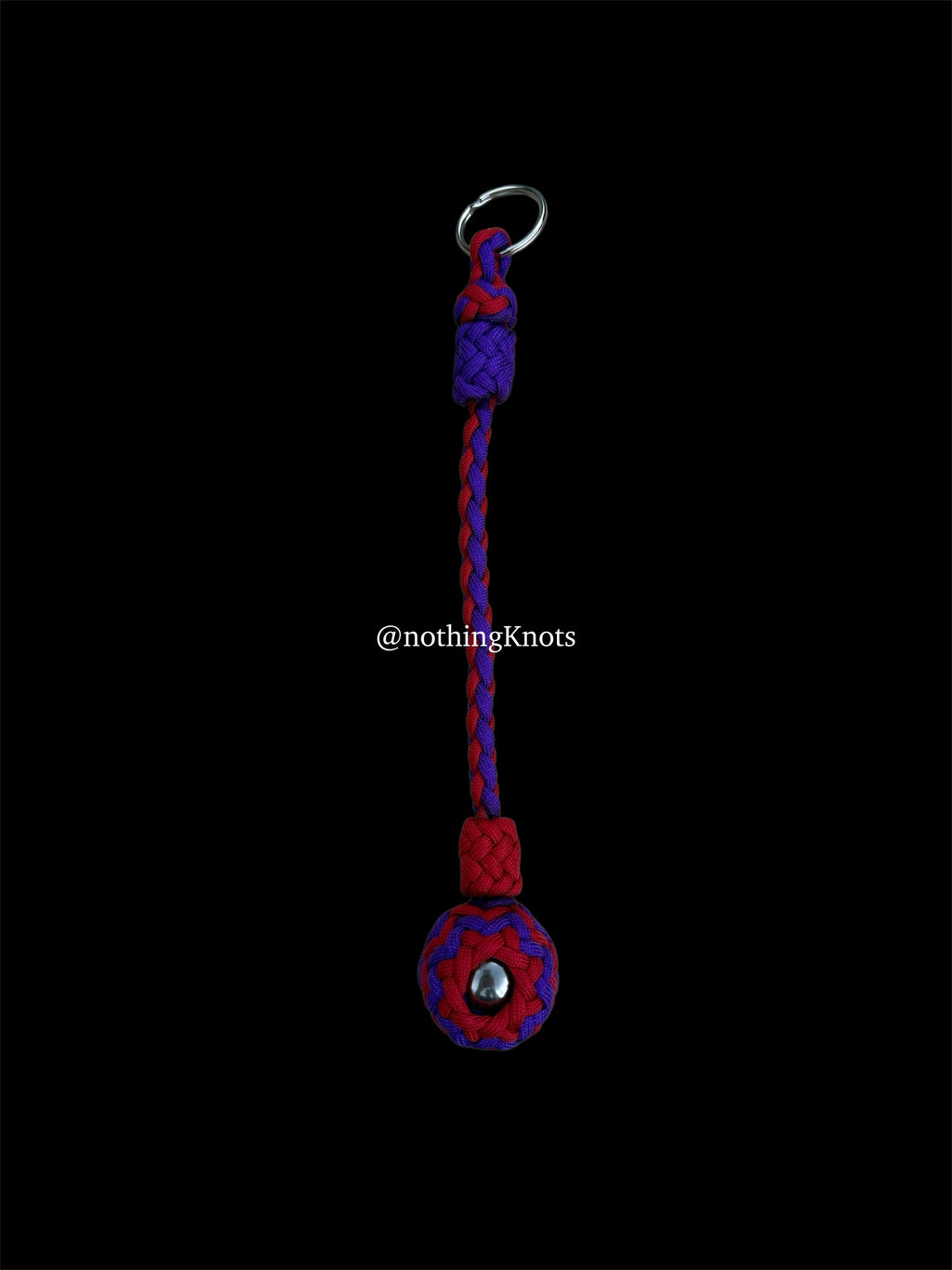Decorative Paracord Wrapped 1.25 inch steel ball in Imperial Red and Acid Purple on a split ring