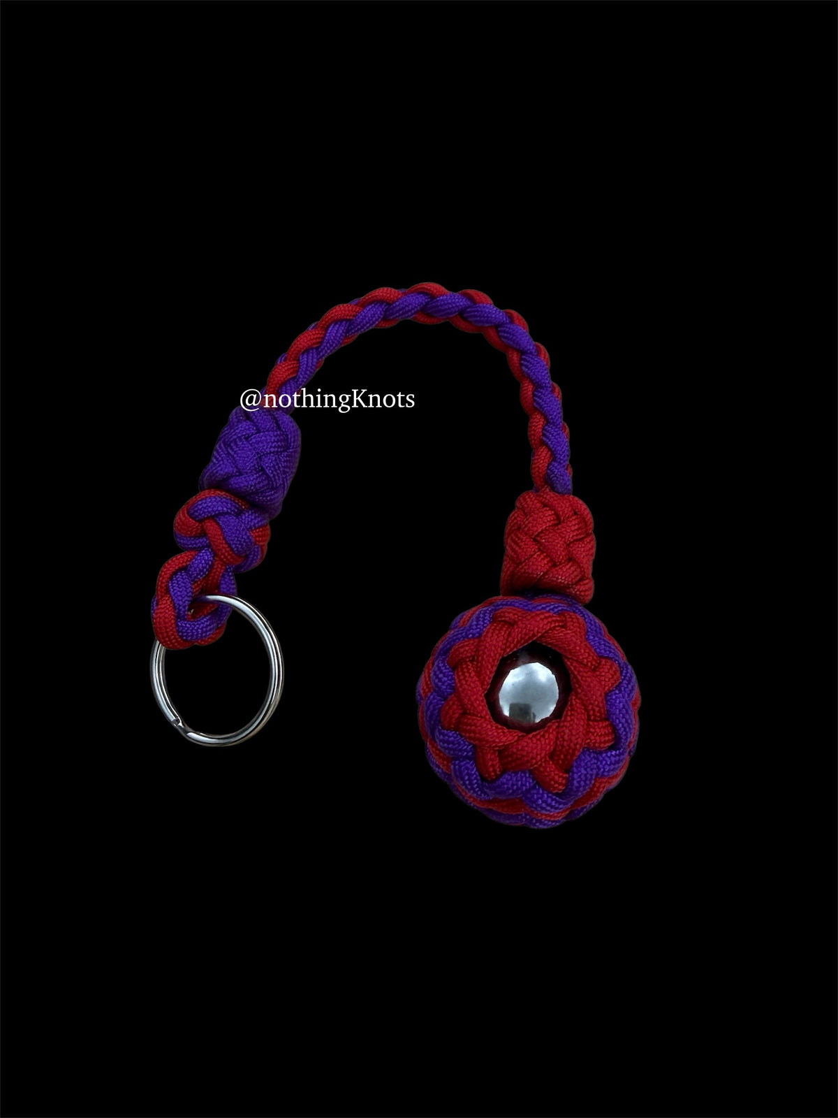 Decorative Paracord Wrapped 1.25 inch steel ball in Imperial Red and Acid Purple on a split ring